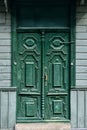 Old wooden carved door bells painted with green oil paint with bronze handle and steel lock Royalty Free Stock Photo