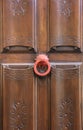 Old wooden carved door and vintage knocker Royalty Free Stock Photo