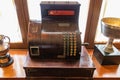 Old wooden cash register with round keypad and crank Royalty Free Stock Photo