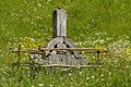 An old wooden Celtic cross in a green meadow