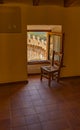 Old wooden chair in front of open window Royalty Free Stock Photo