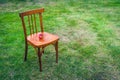 An Old Wooden Chair on the Green Lawn with Two Ripe Red Apples on the Seat. Copy Space