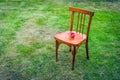 An Old Wooden Chair on the Green Lawn with Two Ripe Red Apples on the Seat. Copy Space Royalty Free Stock Photo