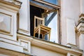 Old wooden chair in window of house in Vyborg Royalty Free Stock Photo