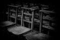 Old Wooden Chairs in Row in a Church in Black and White Royalty Free Stock Photo