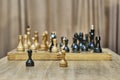Old wooden chess pieces on chessboard.White and black pawns in foreground. Beginning of chess match. Royalty Free Stock Photo