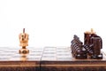 Old wooden Chessboard with lonely King versus opposing team, white background, copy space Royalty Free Stock Photo