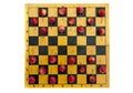 Old wooden chessboard with red crab apples Royalty Free Stock Photo