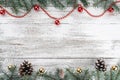 Old wooden Christmas background. Fir branches and cones. Gold and red baubles and garlands Royalty Free Stock Photo