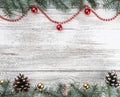 Old wooden Christmas background. Fir branches and cones. Gold and red baubles and garlands. Top view. Space for your text. Xmas Royalty Free Stock Photo