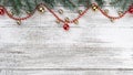 Old wooden Christmas background. Fir branches. Gold and red baubles. Red garlands. Top view. Space for your text. Xmas card. Royalty Free Stock Photo