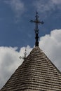 old wooden church against the blue sky in Ukraine, wooden roof with a cross Royalty Free Stock Photo