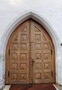 Old wooden church arch door exterior in old european city Royalty Free Stock Photo