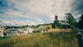 Old wooden church Nercon with an old cemetery on Chiloe with a single church tower and white columns in the entrance