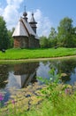 Old wooden church is reflected in water Royalty Free Stock Photo