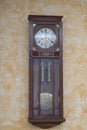 Old wooden clock with a pendulum hanging Royalty Free Stock Photo