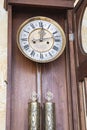 Old wooden clock with a pendulum hanging Royalty Free Stock Photo