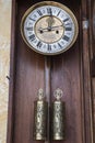 Old wooden clock with a pendulum hanging Royalty Free Stock Photo