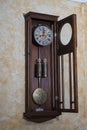 Old wooden clock with a pendulum hanging on Royalty Free Stock Photo