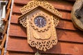 Old wooden clock with a pendulum hanging on the wall in Czech Royalty Free Stock Photo