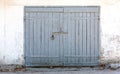 Old wooden closed gate on white painted plaster wall Royalty Free Stock Photo