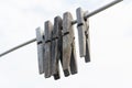 Old wooden clothespegs hanging on rope