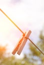 An old wooden clothespin on a rope against the sky. Vertical. Copy space. Royalty Free Stock Photo