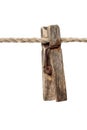 An old wooden clothespin on a rope. Royalty Free Stock Photo