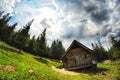 old wooden cottage cheese factory in a clearing high in the mountains. Royalty Free Stock Photo