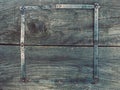 On the old, wooden, cracked, the working surface in the workshop is a vintage, used, rusty, foldable measuring tool - me Royalty Free Stock Photo