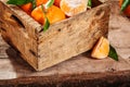 Old wooden crate with fresh tangerines