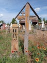 Old wooden cross with an iron grave lamp
