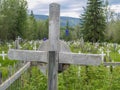 Old wooden. cross close up with defocused field of white crosses of graveyard Royalty Free Stock Photo