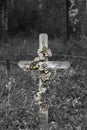 Old Wooden Cross with Faded Flowers