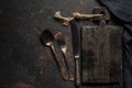 Old wooden cutting board, vintage cutlery and towel on black stone kitchen table. Top view flat lay with copy space Royalty Free Stock Photo