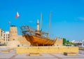 Old wooden dhow in front of the Al Fahidi fort converted into the Dubai Museum, UAE