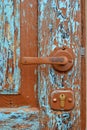 Old, wooden, dilapidated door with blue paint