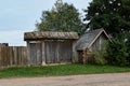 Old wooden dilapidated village house with gate