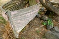 Old wooden dinghy from bow and inside ribs and structure under tree on damp winter day Royalty Free Stock Photo