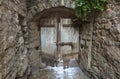 Old wooden door of an ancient castle in a stone wall Royalty Free Stock Photo