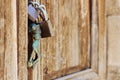 Old door with antique brass knocker in the shape of a hand Royalty Free Stock Photo