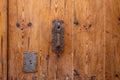 Old wooden brown door with antique door handle. Close up. Detail.