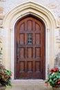 Old Wooden Door with Arched Doorway on Historic Stone Building