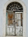 Old wooden door. Arched doorway, Iron pattern over the door. Weathered and distressed. Dubrovnik, Croatia. Royalty Free Stock Photo