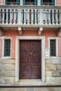 Old wooden door and balcony in italian traditional house Royalty Free Stock Photo
