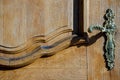 Old wooden door with a beautiful decorative metal door handle. entrance to the old church Royalty Free Stock Photo