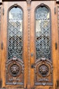 Old wooden door. Big two heads of lion on the front . vintage door knocker. Royalty Free Stock Photo