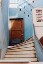 Old wooden door on blue plastered wall Royalty Free Stock Photo