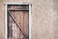 Old wooden door from boards and a battered wall, copy space for text Royalty Free Stock Photo