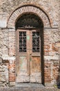 Old wooden door with brick archway. Royalty Free Stock Photo